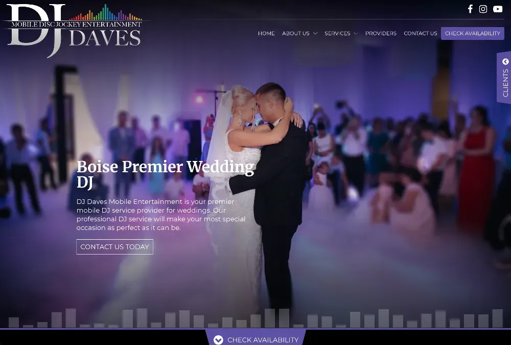 Bride and groom share a first dance under soft lights while guests watch from the crowded dance floor.